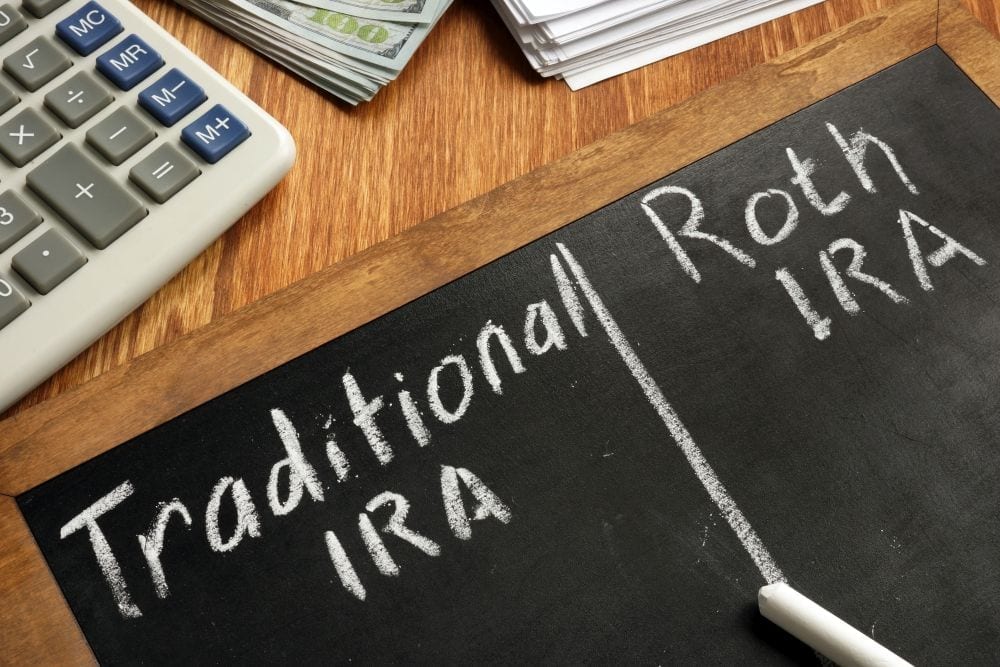 Roth IRA vs Trad IRA on chalkboard